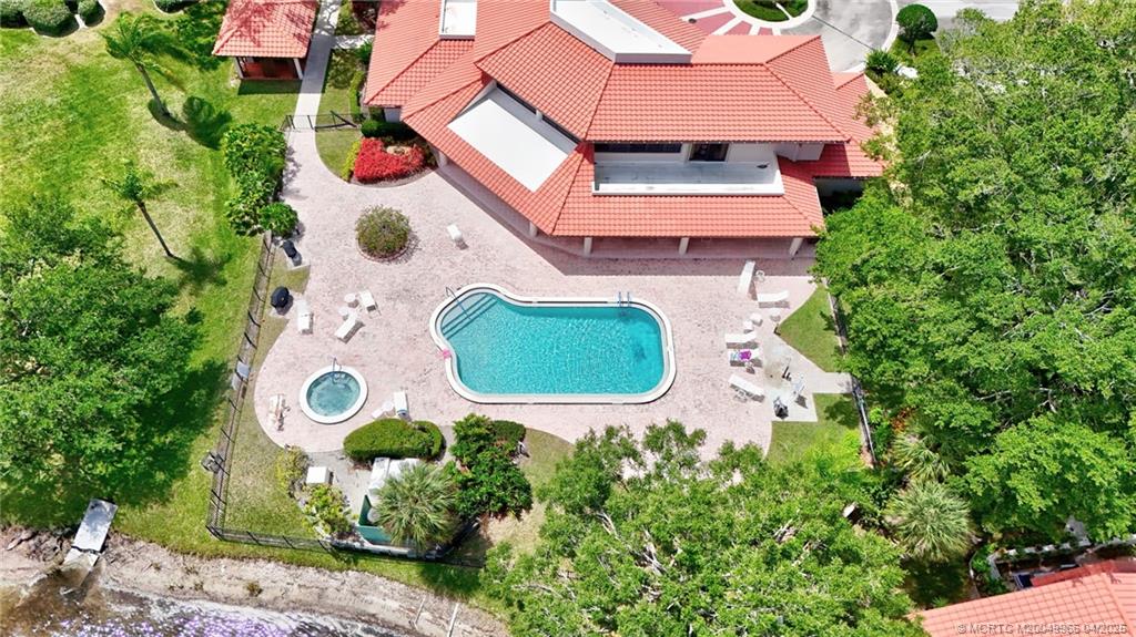 3401 Southeast Martinique Trace, Unit 101 Stuart, FL 34997 - Photo 49 of 51 an aerial view of a house with outdoor space and street view