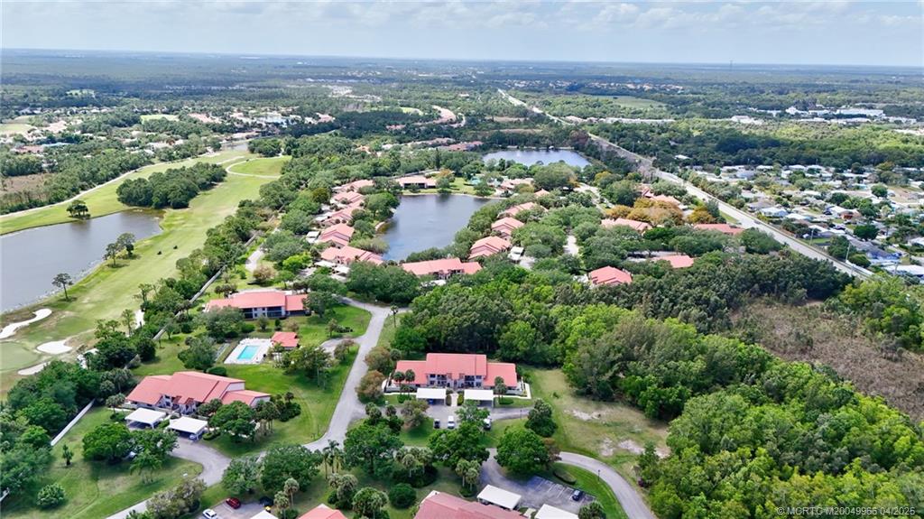3401 Southeast Martinique Trace, Unit 101 Stuart, FL 34997 - Photo 51 of 51 an aerial view of residential houses with outdoor space and trees
