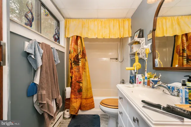 a bedroom with a bed and large windows