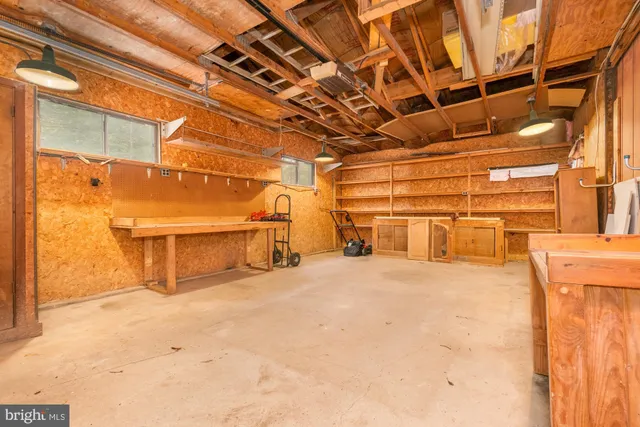 a front view of a house with large trees