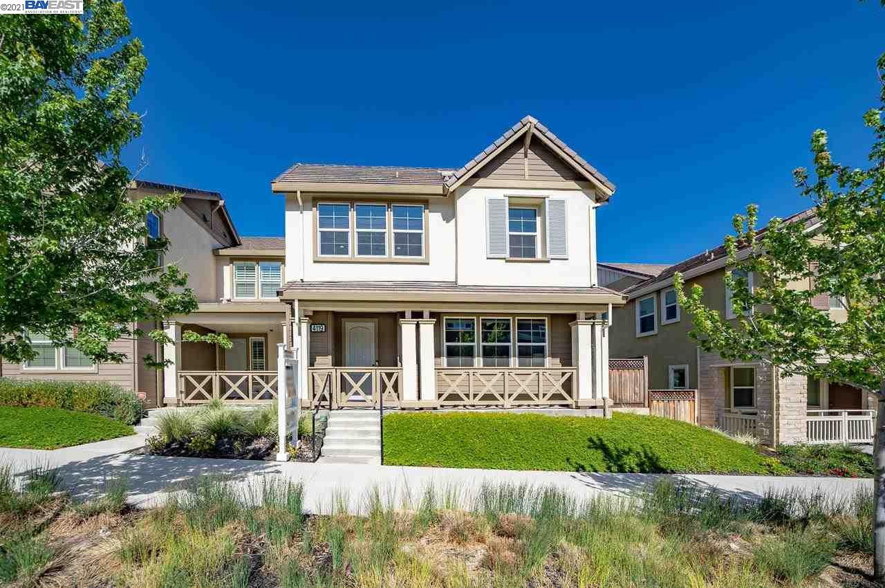 a view of house with a yard and plants