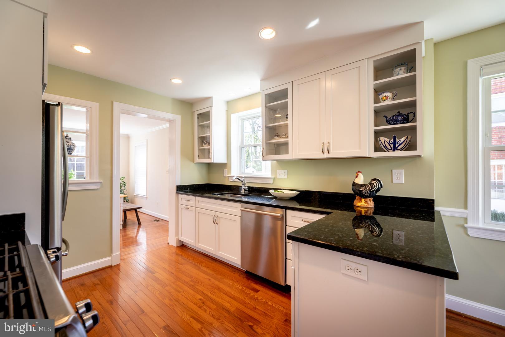 10009 Raynor Road Silver Spring, MD 20901 - Photo 11 of 34 a kitchen with stainless steel appliances granite countertop a sink stove and cabinets