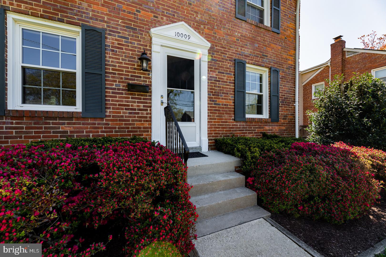 10009 Raynor Road Silver Spring, MD 20901 - Photo 3 of 34 a view of a house with a flower garden and flower plants