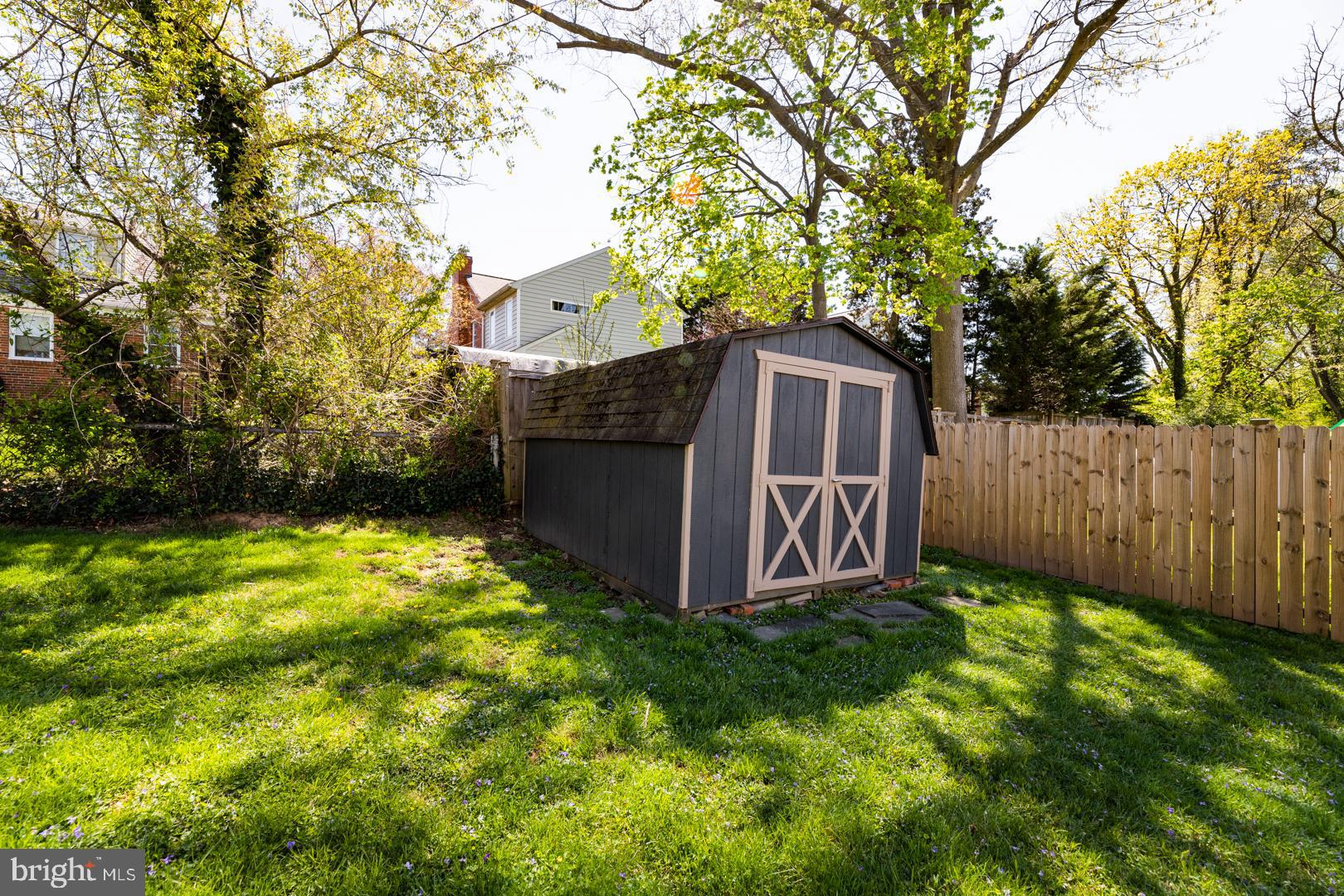 10009 Raynor Road Silver Spring, MD 20901 - Photo 31 of 34 a view of a backyard with a barn and large trees