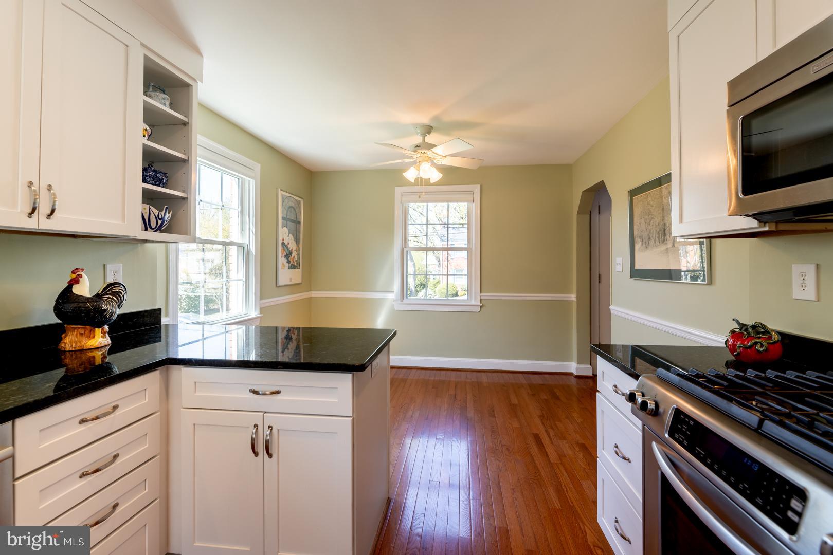 10009 Raynor Road Silver Spring, MD 20901 - Photo 10 of 34 a kitchen with granite countertop a stove and a wooden floor