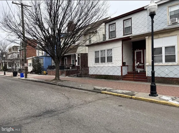 a front view of a house with a street