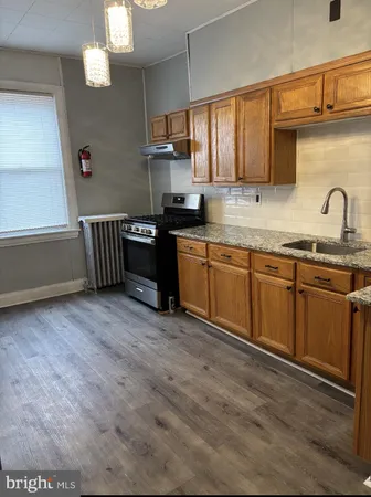 a kitchen with sink cabinets and window