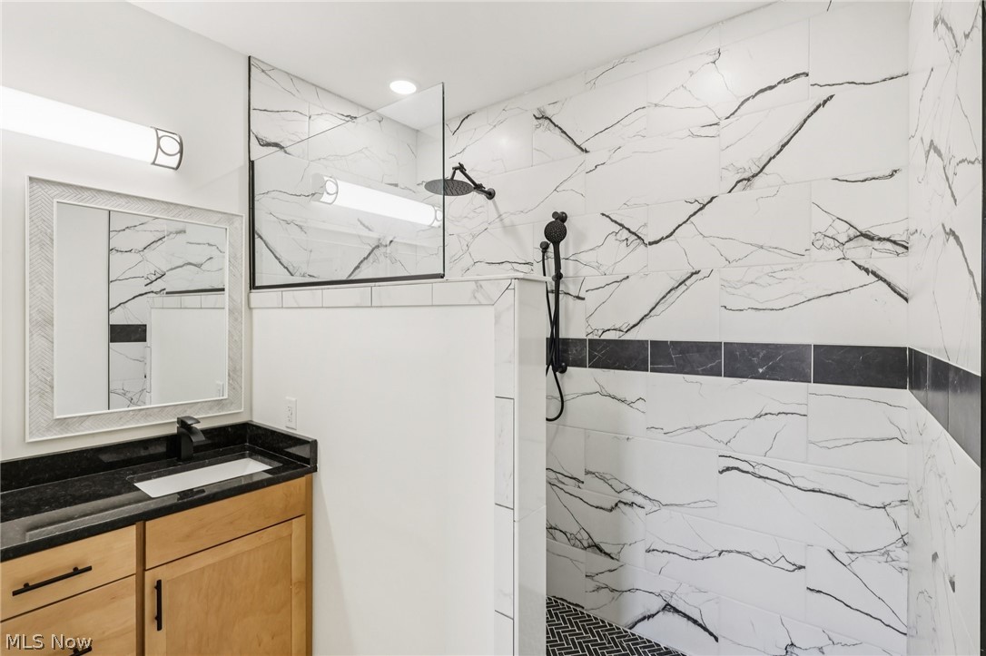 6535 North Ridge Road West Geneva, OH 44041 - Photo 29 of 48 Full bathroom featuring a marble finish shower and vanity