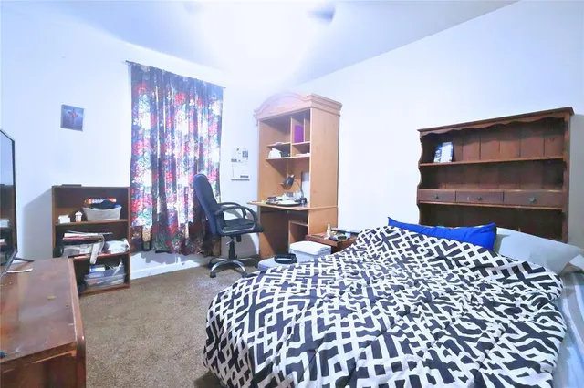 a bedroom with furniture and a window