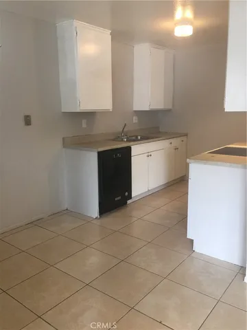 a kitchen with stainless steel appliances a sink stove and cabinets