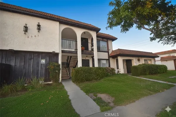 a front view of a house with a garden
