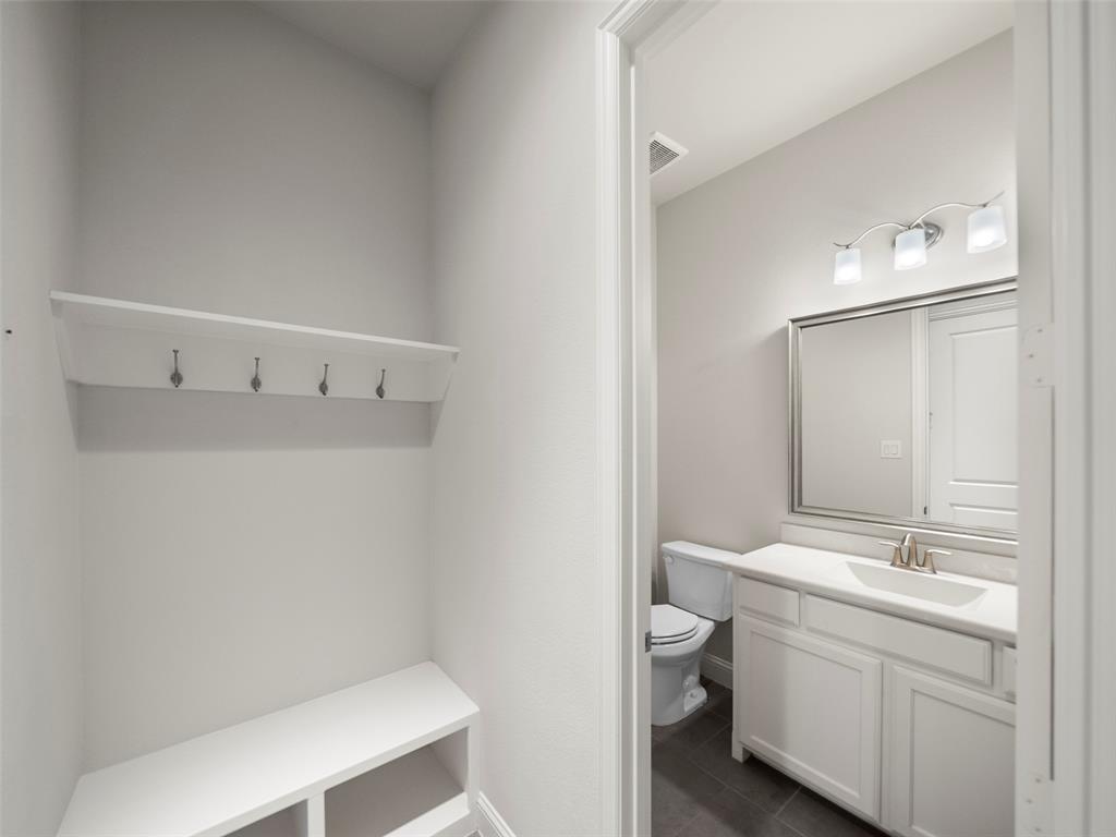3044 Bold Ruler Road Celina, TX 75009 - Photo 20 of 36 a bathroom with a sink a toilet and a mirror