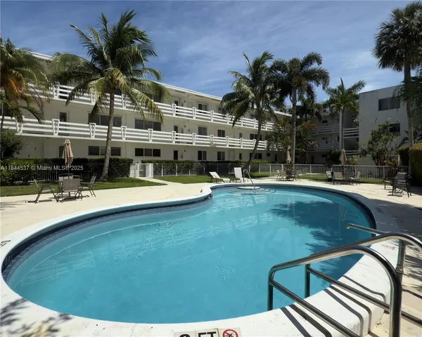 a view of swimming pool with outdoor seating and plants