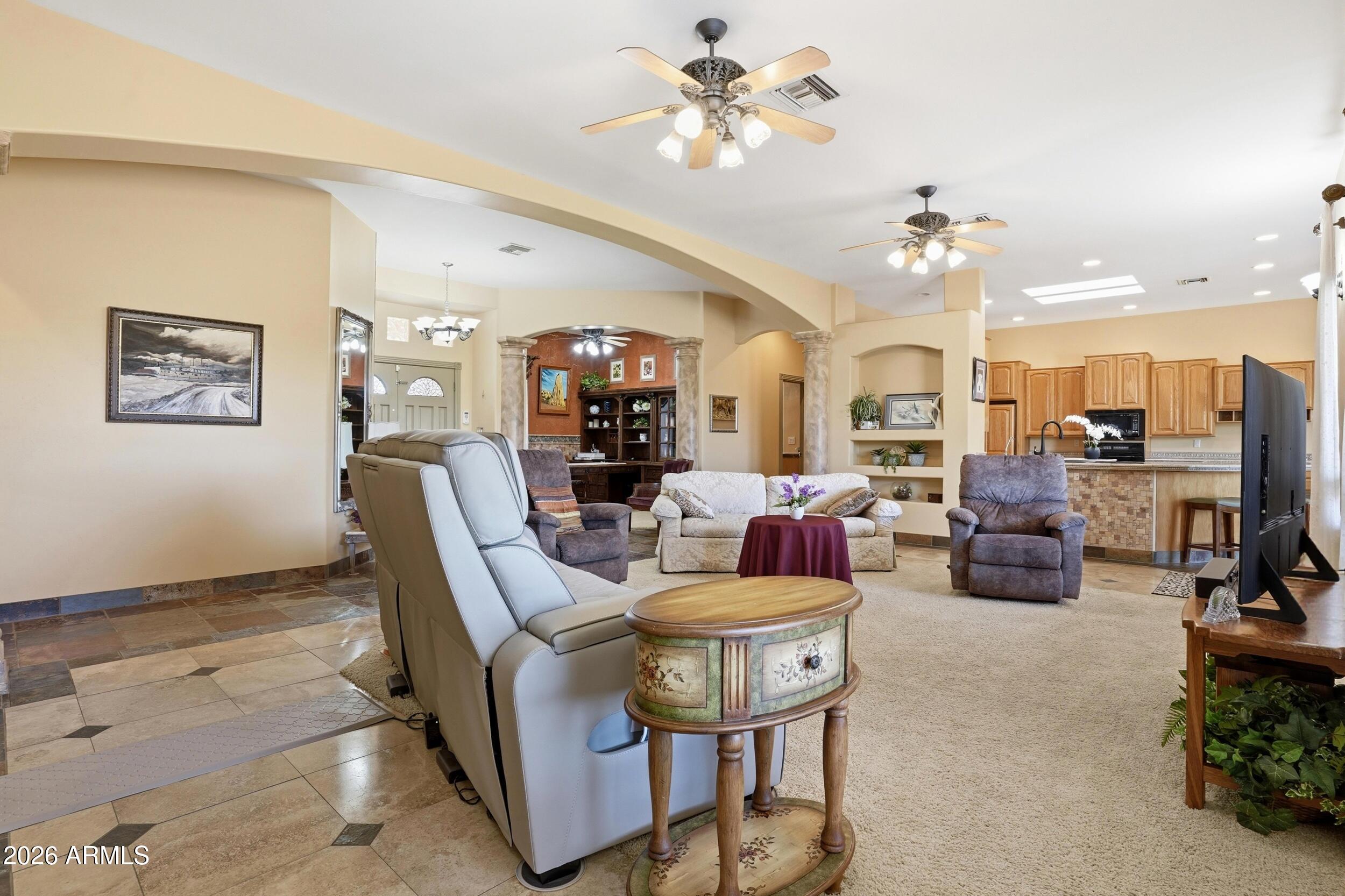 6334 East Albany Street Mesa, AZ 85205 - Photo 15 of 72 a living room with lots of furniture and a chandelier