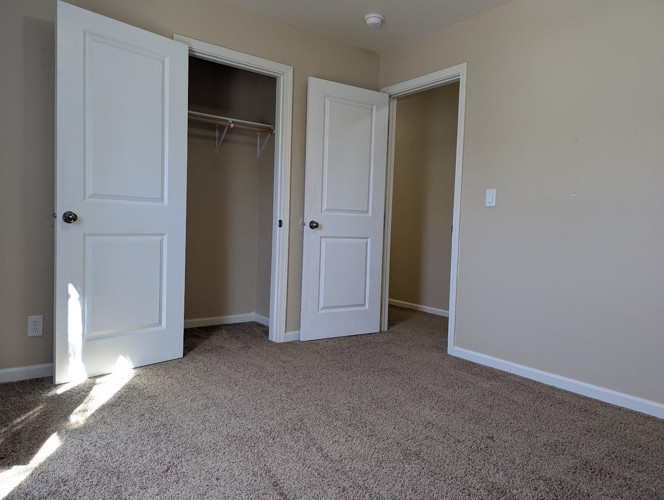 435 32 Road, Unit 907 Clifton, CO 81520 - Photo 15 of 24 an empty room with closet and wooden door