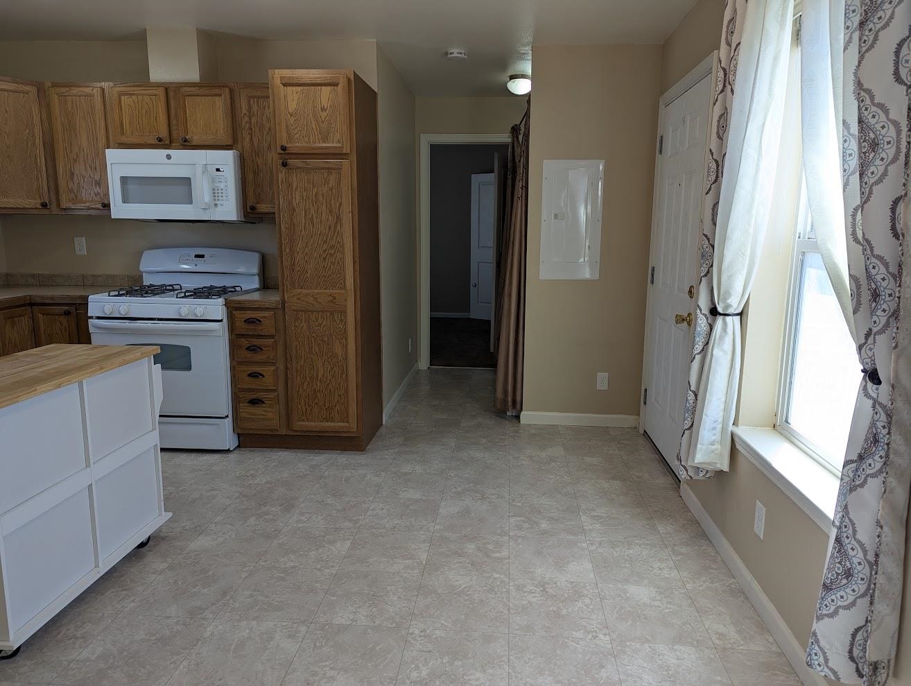 435 32 Road, Unit 907 Clifton, CO 81520 - Photo 5 of 24 a view of kitchen with refrigerator stove and wooden cabinets