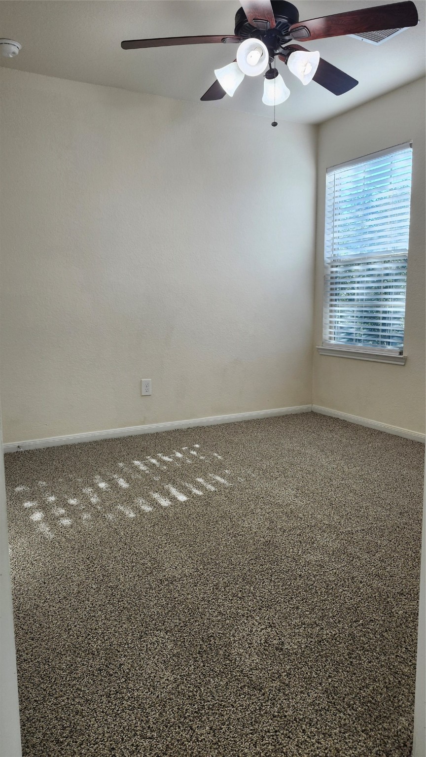 17122 Amarose Drive Houston, TX 77090 - Photo 11 of 12 an empty room with a window and a fan