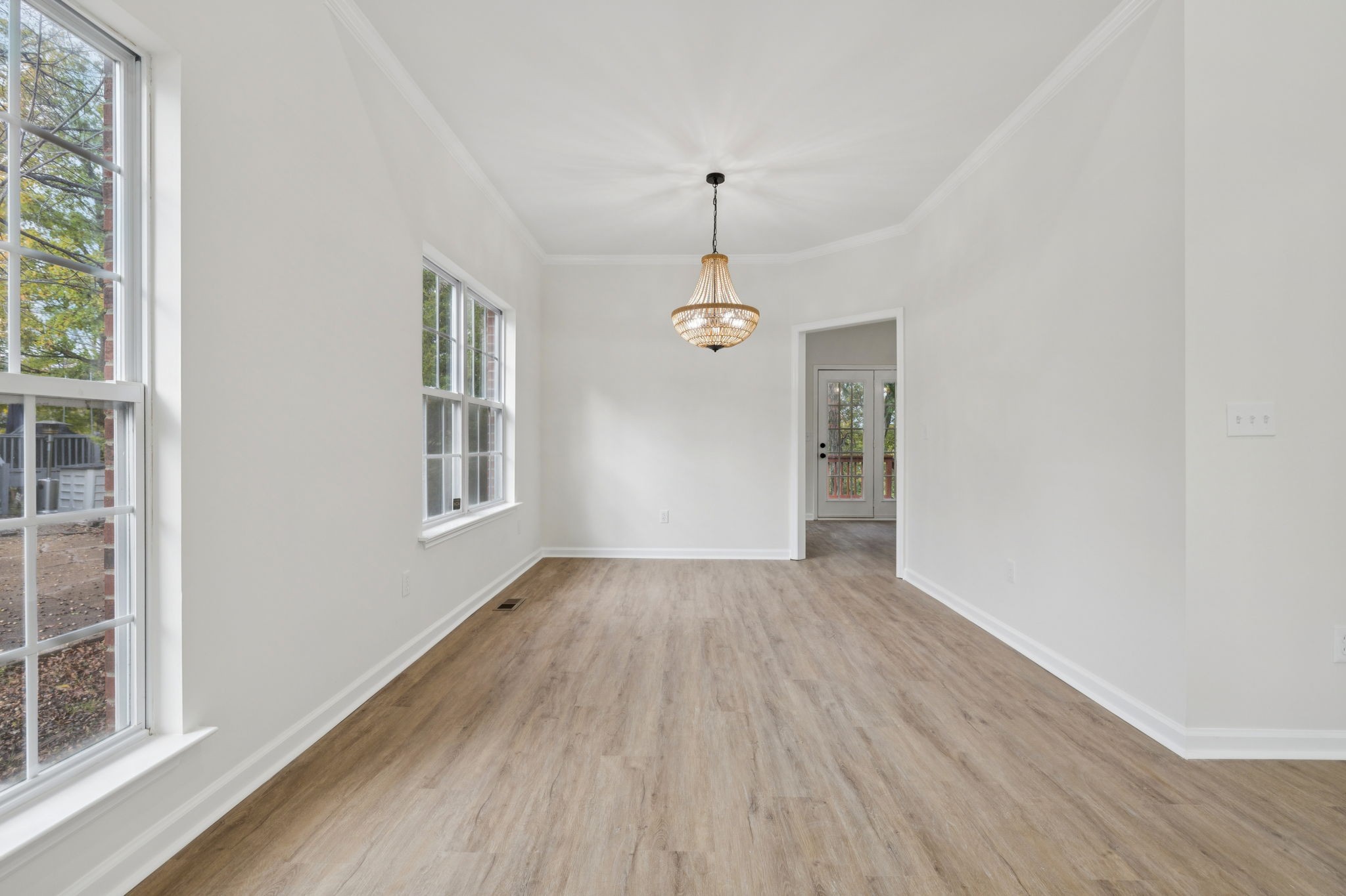 4909 John Hagar Road Hermitage, TN 37076 - Photo 11 of 67 an empty room with wooden floor chandelier and windows