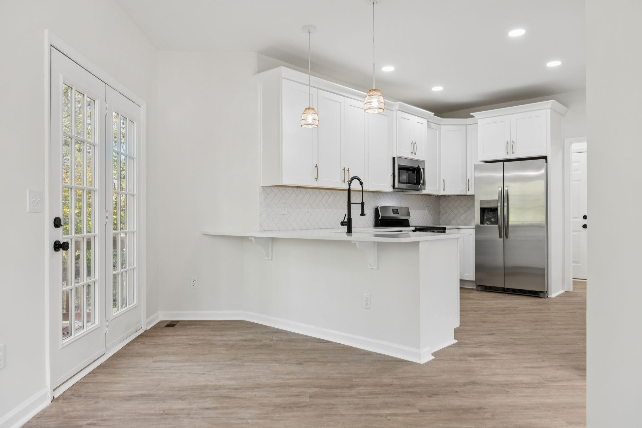 4909 John Hagar Road Hermitage, TN 37076 - Photo 26 of 67 a kitchen with white cabinets and stainless steel appliances
