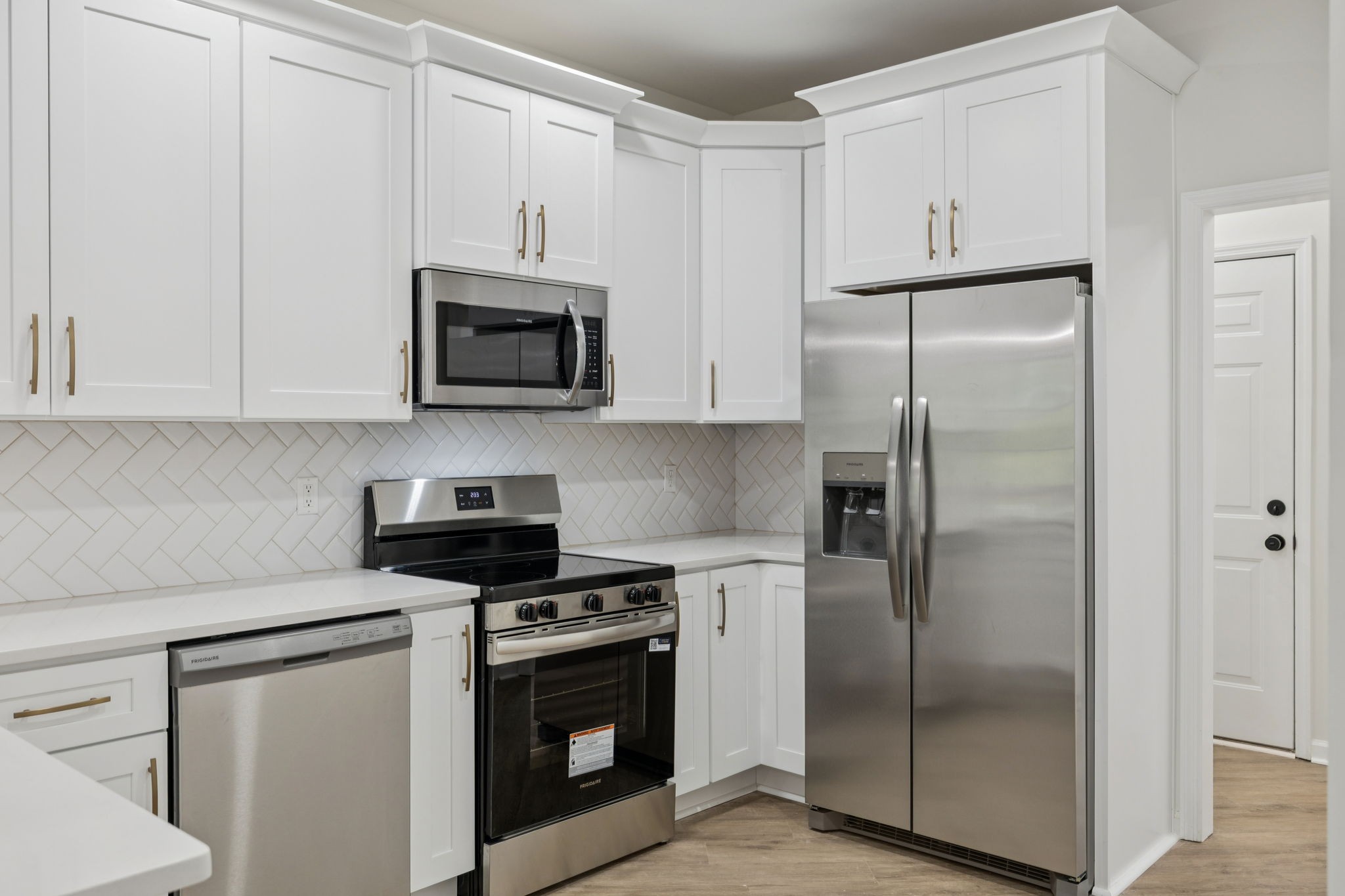 4909 John Hagar Road Hermitage, TN 37076 - Photo 27 of 67 a kitchen with refrigerator a microwave and cabinets