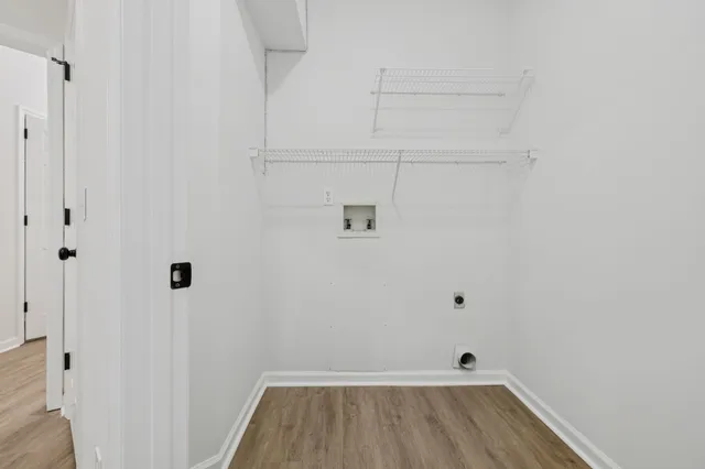 an empty room with a ceiling fan and window