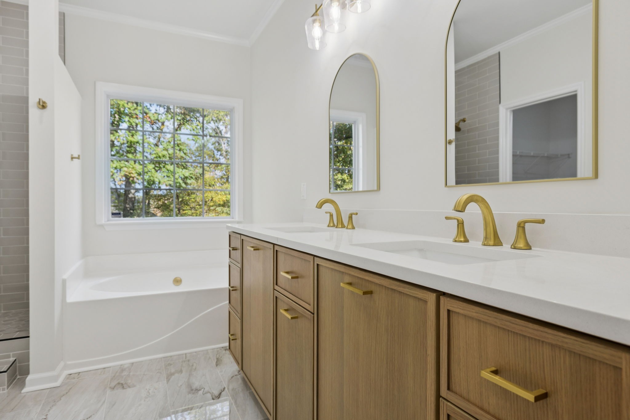 4909 John Hagar Road Hermitage, TN 37076 - Photo 33 of 67 a bathroom with a tub sink and mirror