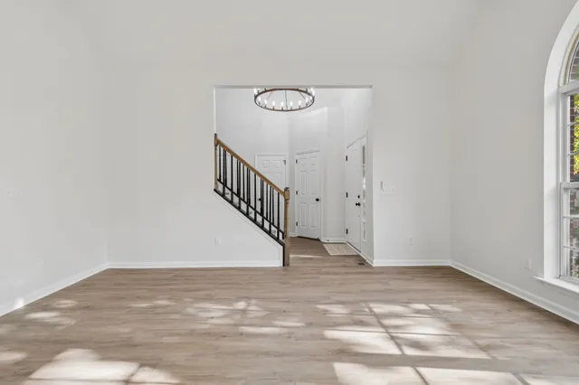 a view of an empty room with a window and fireplace