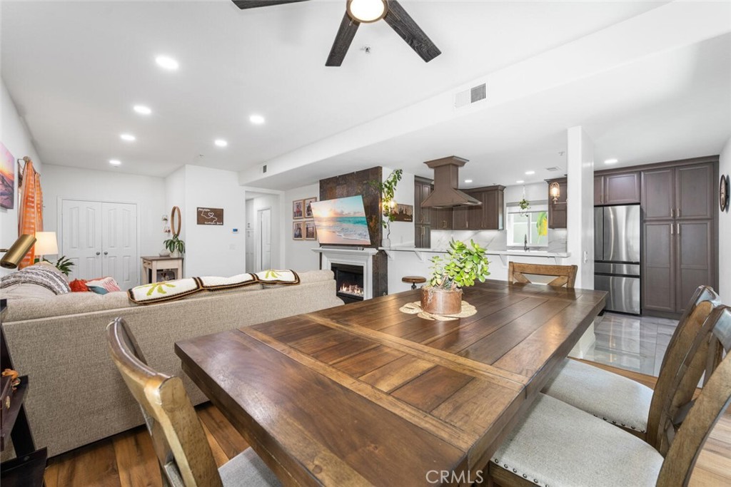 1516 Pacific Coast Highway, Unit 101 Huntington Beach, CA 92648 - Photo 58 of 58 a view of a dining room and livingroom with furniture wooden floor a chandelier