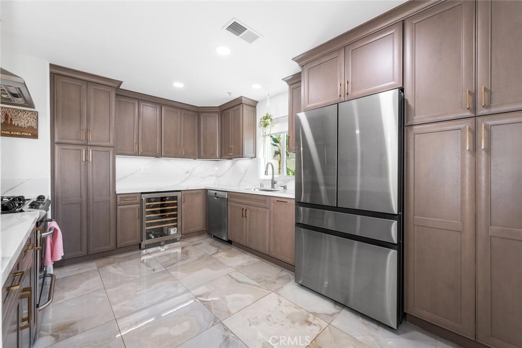 1516 Pacific Coast Highway, Unit 101 Huntington Beach, CA 92648 - Photo 14 of 58 a kitchen with granite countertop a refrigerator and a sink