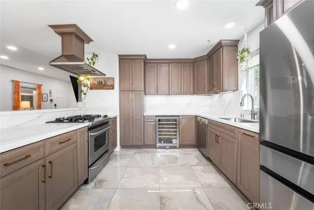 a kitchen with stainless steel appliances granite countertop a refrigerator and a sink