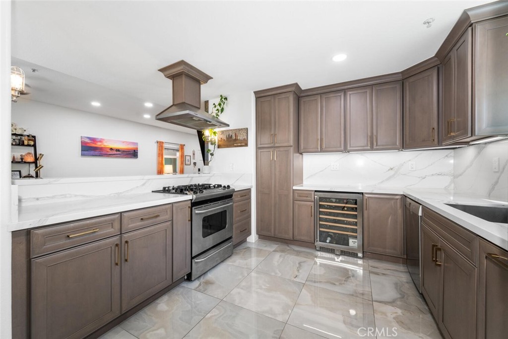1516 Pacific Coast Highway, Unit 101 Huntington Beach, CA 92648 - Photo 16 of 58 a kitchen with a stove sink and cabinets