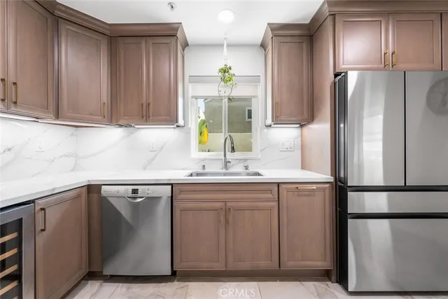 a kitchen with stainless steel appliances granite countertop a stove and a refrigerator