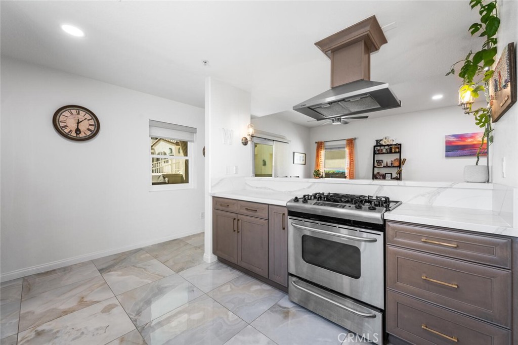 1516 Pacific Coast Highway, Unit 101 Huntington Beach, CA 92648 - Photo 20 of 58 a kitchen with stainless steel appliances granite countertop a stove and a refrigerator