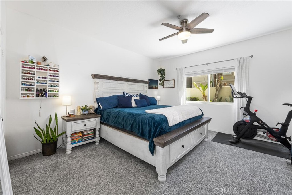 1516 Pacific Coast Highway, Unit 101 Huntington Beach, CA 92648 - Photo 21 of 58 Primary bedroom with premium carpet, new windows and ceiling fan.