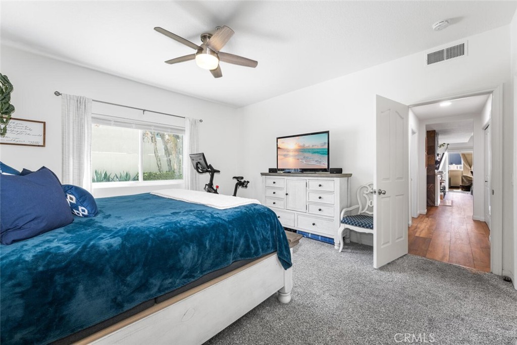 1516 Pacific Coast Highway, Unit 101 Huntington Beach, CA 92648 - Photo 22 of 58 a spacious bedroom with a bed and a flat tv screen on dresser