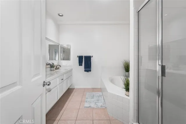 a bedroom with a bed and windows