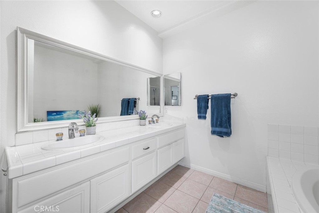 1516 Pacific Coast Highway, Unit 101 Huntington Beach, CA 92648 - Photo 25 of 58 a bathroom with a sink and a mirror