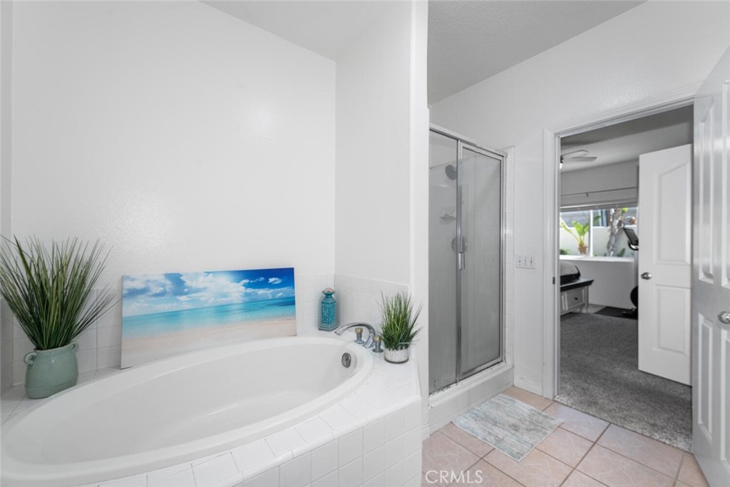1516 Pacific Coast Highway, Unit 101 Huntington Beach, CA 92648 - Photo 26 of 58 a bathroom with a bathtub and a shower