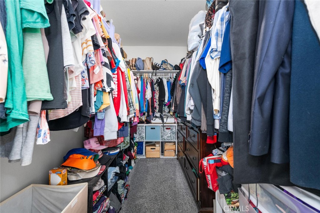 1516 Pacific Coast Highway, Unit 101 Huntington Beach, CA 92648 - Photo 27 of 58 a view of walk in closet with clothes and shoes