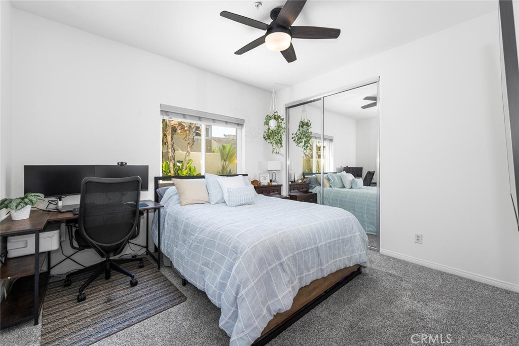 1516 Pacific Coast Highway, Unit 101 Huntington Beach, CA 92648 - Photo 28 of 58 a bedroom with a bed and windows