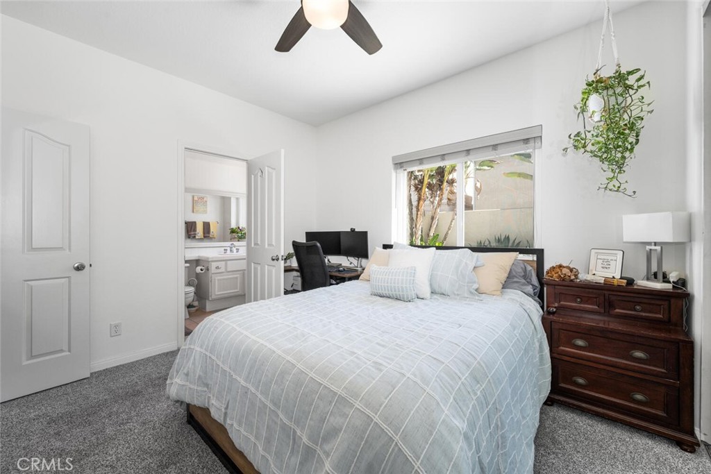 1516 Pacific Coast Highway, Unit 101 Huntington Beach, CA 92648 - Photo 29 of 58 a bedroom with a bed and a chandelier