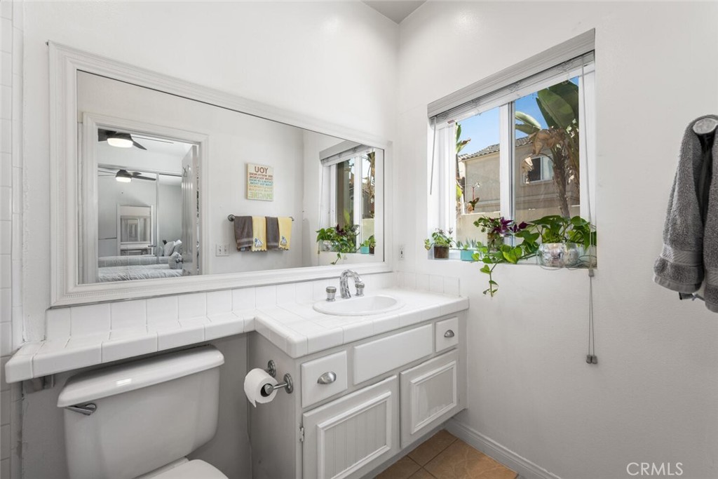 1516 Pacific Coast Highway, Unit 101 Huntington Beach, CA 92648 - Photo 31 of 58 a bathroom with a sink and a mirror