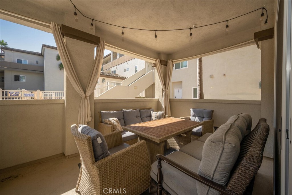 1516 Pacific Coast Highway, Unit 101 Huntington Beach, CA 92648 - Photo 35 of 58 a view of a dining room with furniture and a window