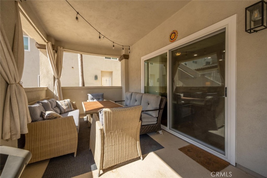 1516 Pacific Coast Highway, Unit 101 Huntington Beach, CA 92648 - Photo 36 of 58 a living room with furniture and a glass door