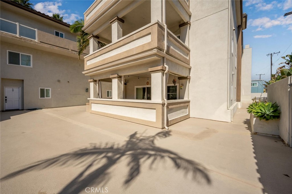 1516 Pacific Coast Highway, Unit 101 Huntington Beach, CA 92648 - Photo 39 of 58 a view of a balcony with potted plants