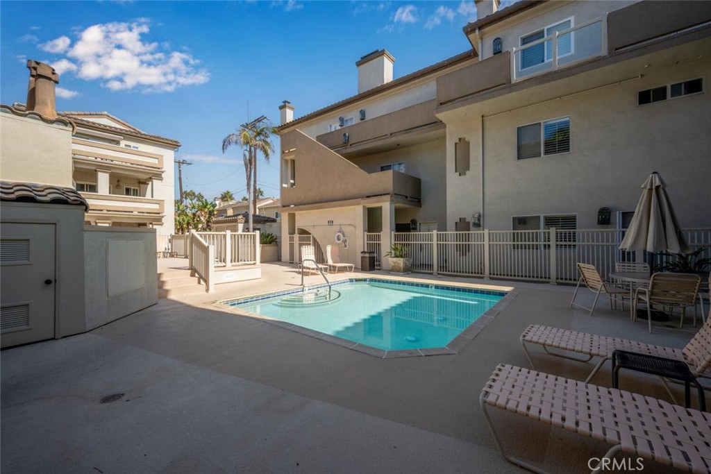 1516 Pacific Coast Highway, Unit 101 Huntington Beach, CA 92648 - Photo 41 of 58 a view of a house with pool and chairs