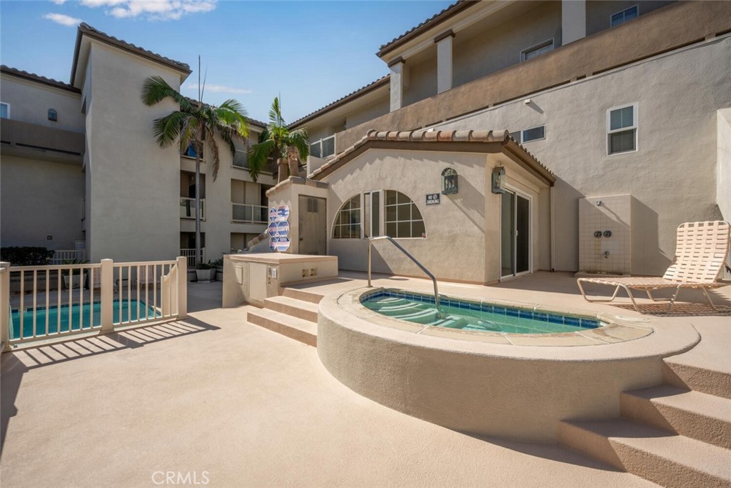 1516 Pacific Coast Highway, Unit 101 Huntington Beach, CA 92648 - Photo 43 of 58 a front view of a house with a garden