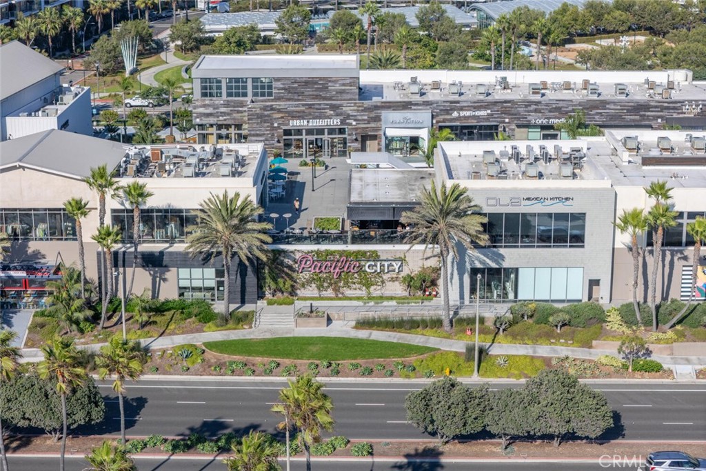1516 Pacific Coast Highway, Unit 101 Huntington Beach, CA 92648 - Photo 57 of 58 a view of building with yard and swimming pool