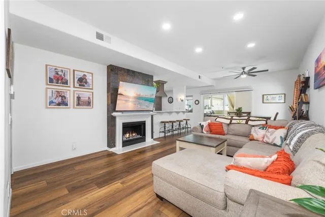 a view of a hallway with wooden floor and a potted plant