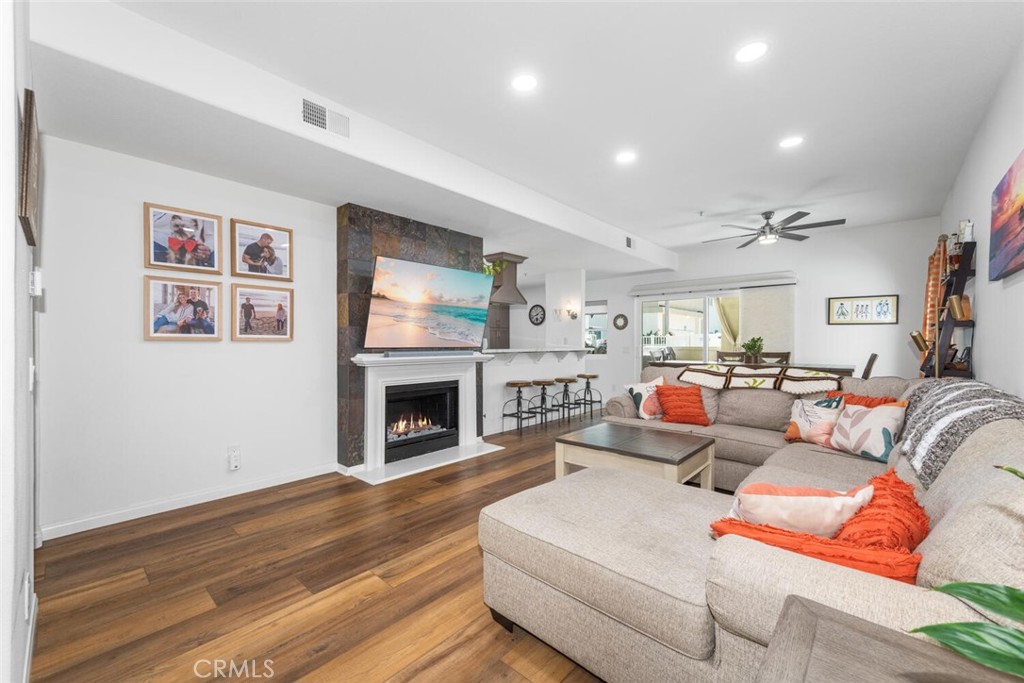 1516 Pacific Coast Highway, Unit 101 Huntington Beach, CA 92648 - Photo 6 of 58 a living room with furniture and a fireplace